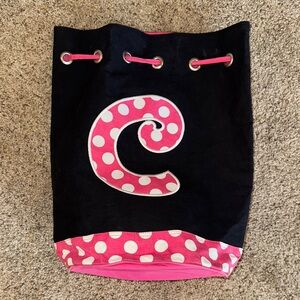 Black bag with pink and white letter C